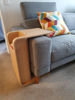 Picture of Side Table next to  bed slotted over the seat of a sofa Ideal for small rooms