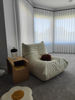 Picture of Side Table next to  bed slotted over the seat of a sofa Ideal for small rooms