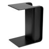 Picture of Black Side Table next to  bed slotted over the seat of a sofa otis side table